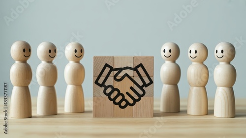 Small wooden figures stand around building blocks illustrating a business partnership agreement