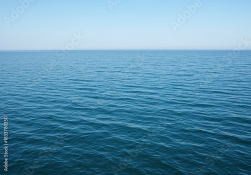 Vast, tranquil saltwater surface shimmering with gentle ripples under natural light. The expansive blue liquid creates a serene and pure natural background ,background ,blue ,climate