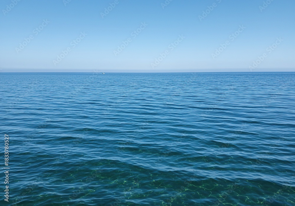 Fototapeta premium Vast, tranquil saltwater surface shimmering with gentle ripples under natural light. The expansive blue liquid creates a serene and pure natural background ,climate ,current ,peace