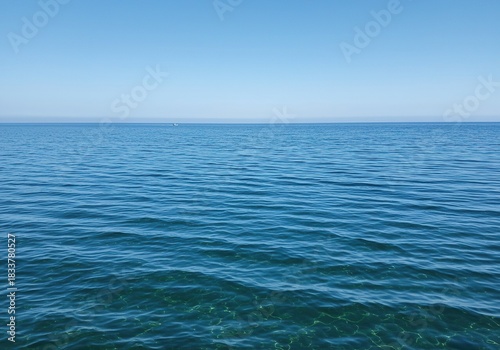 Vast, tranquil saltwater surface shimmering with gentle ripples under natural light. The expansive blue liquid creates a serene and pure natural background ,climate ,current ,peace
