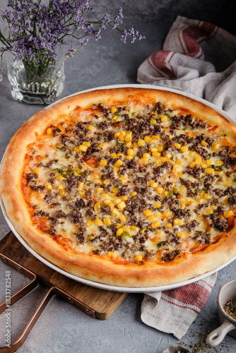Appetizing flatbread with spicy beef and sweet corn topping