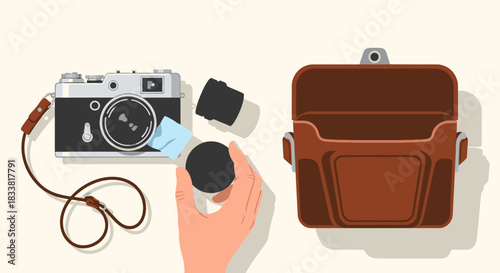A person carefully cleans the lens of a classic film camera, preparing the vintage photographic equipment for an outing, with a leather bag nearby.
