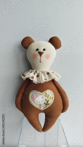 Wallpaper Mural Soft handmade brown bear toy with lace collar and heart applique, simple studio look Torontodigital.ca