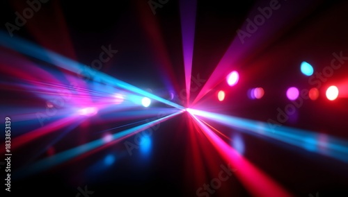 Vibrant laser light show illuminates a dark venue with dynamic beams of pink and blue rays