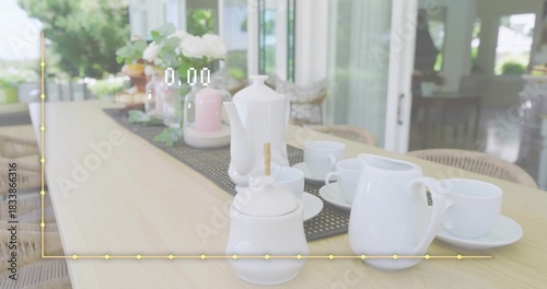 Displaying white ceramic tea set resting on porch table, with runner and yellow graph overlay