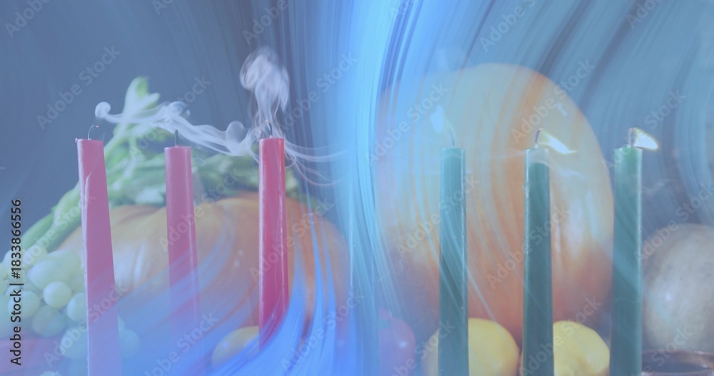 Naklejka premium Displaying group of six taper candles smoking on studio table, with pumpkin, grapes, blue light