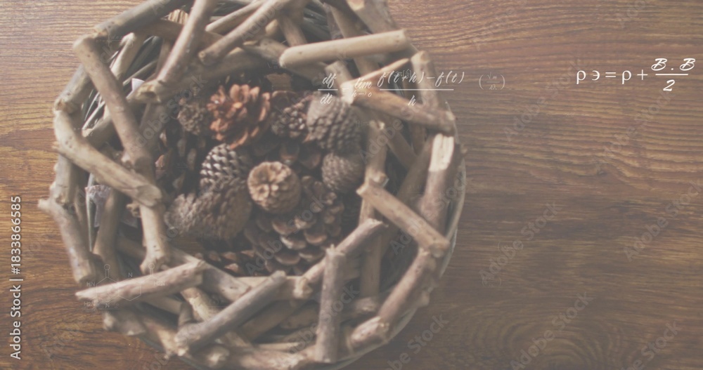 Naklejka premium Displaying woven twig basket left on wood table, holding pine cones, showing white formulas overlay