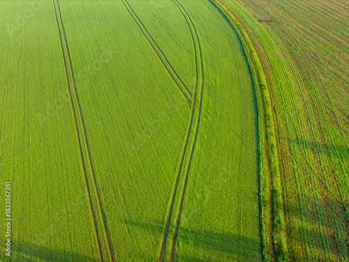 Aerial drone photo over a farmers field in the winter time, showing tractor tracks within the field