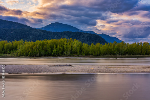 Fraser River flowing through a mountain valley at sunset