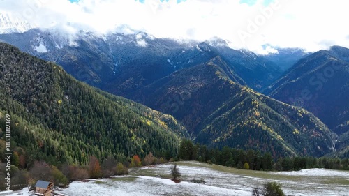 The Snow-Capped Caucasus Peaks Mountain and Autumn Forests near Mestia, Georgia