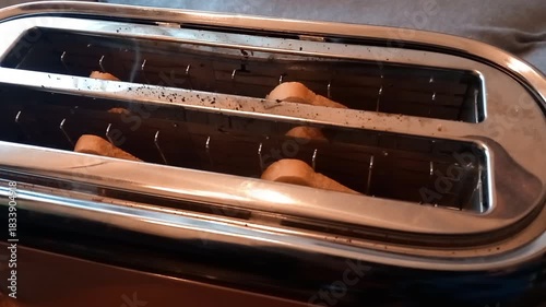 Toaster in action making toast with sounds from lever clicks and heating during toasting cycle