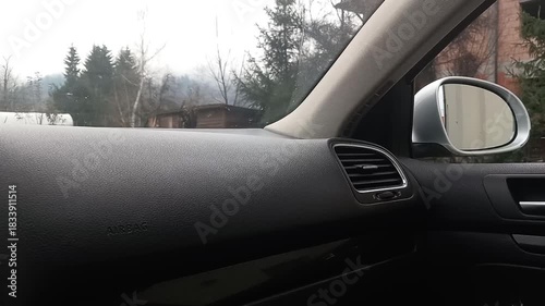 Sounds of electric motor adjusting right side view mirror inside a car with dashboard and exterior view