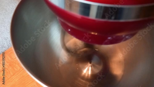 Close up view of dough hook in mixer at high speed with sounds of mixing and action effects present