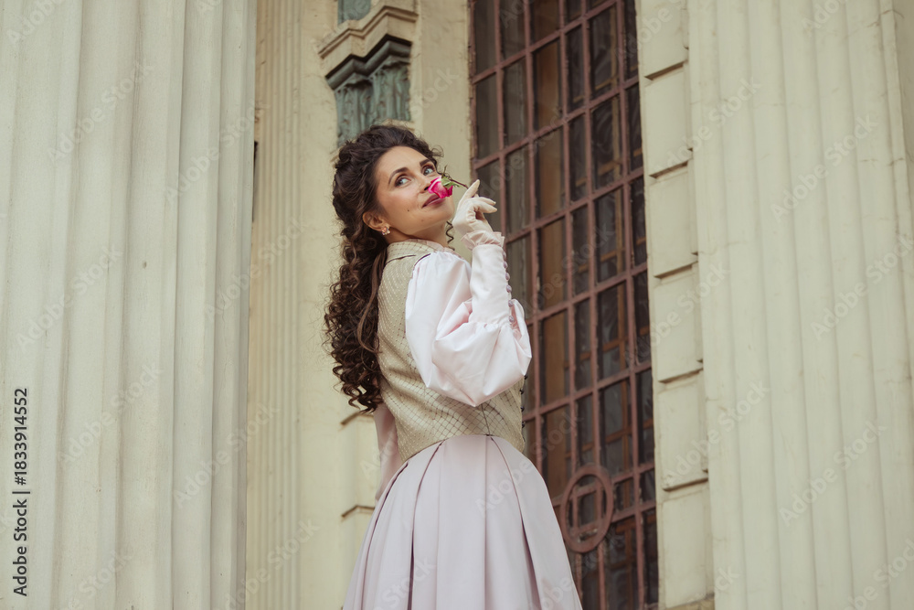 Obraz premium Woman with a rose in an old building