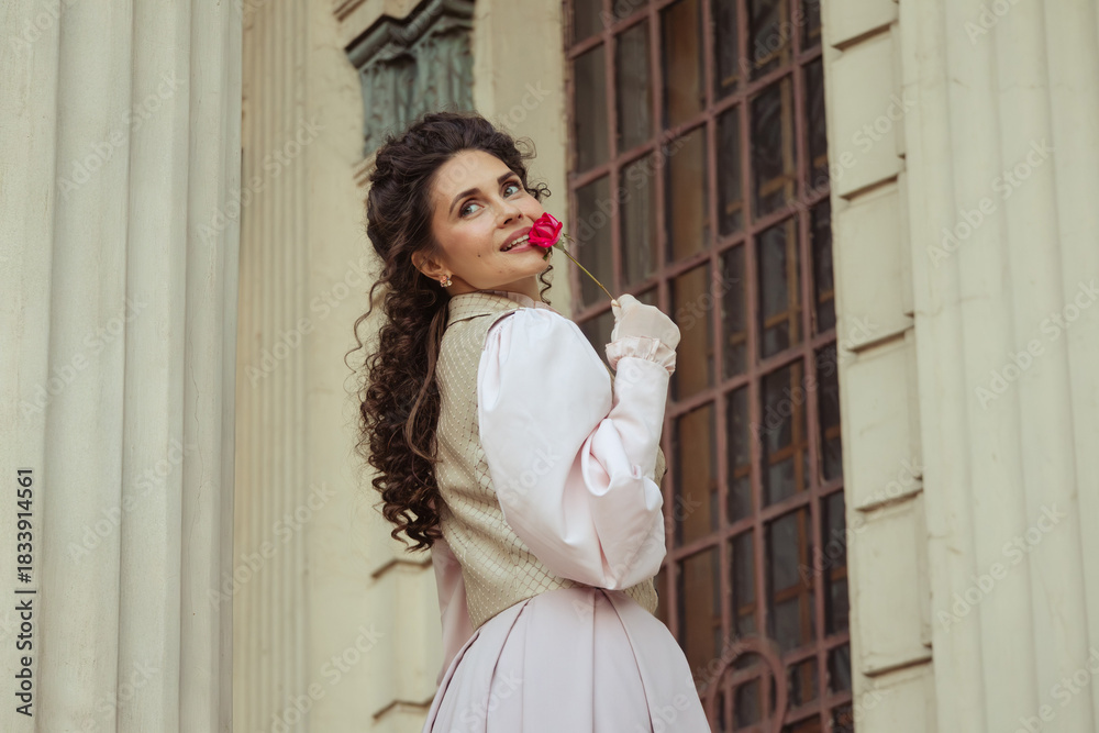 Obraz premium Woman with a rose in an old building