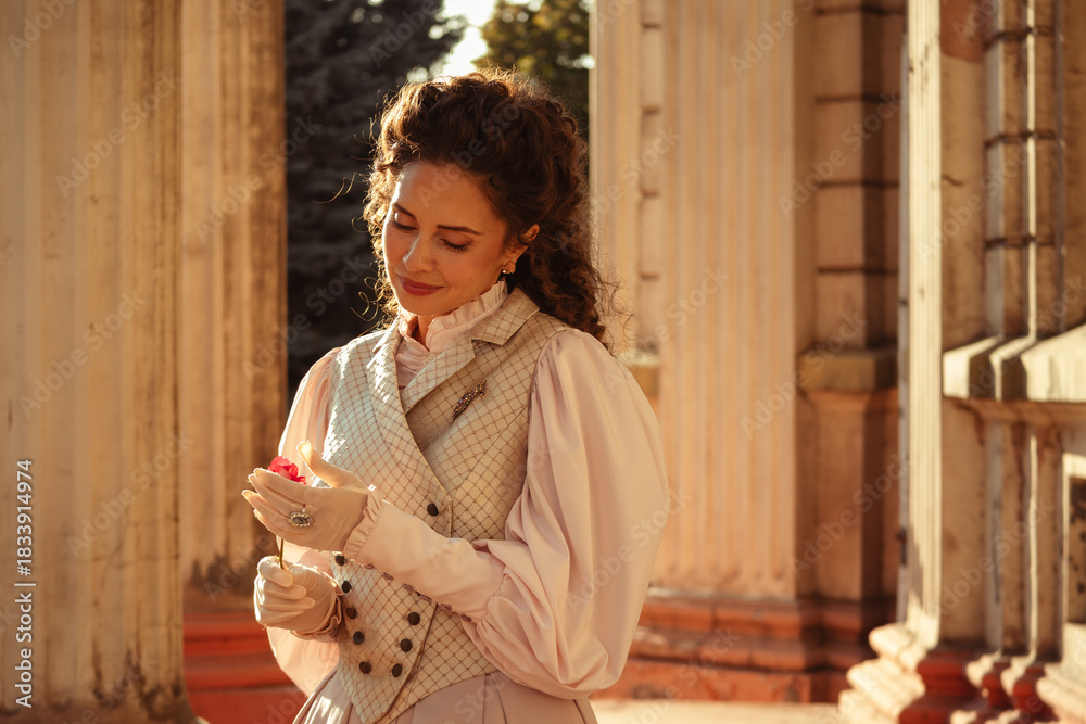 Fototapeta premium Woman with a rose in an old building