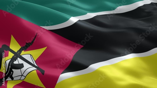 Dynamic Mozambique flag waving proudly in the wind showing its national colors and emblem, a symbol of patriotism and national pride