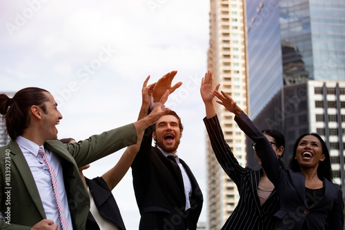 Business Team Celebrating Success with a High Five Outdoors