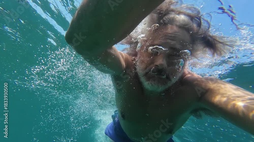 man swimming in the Orta lake, Italy