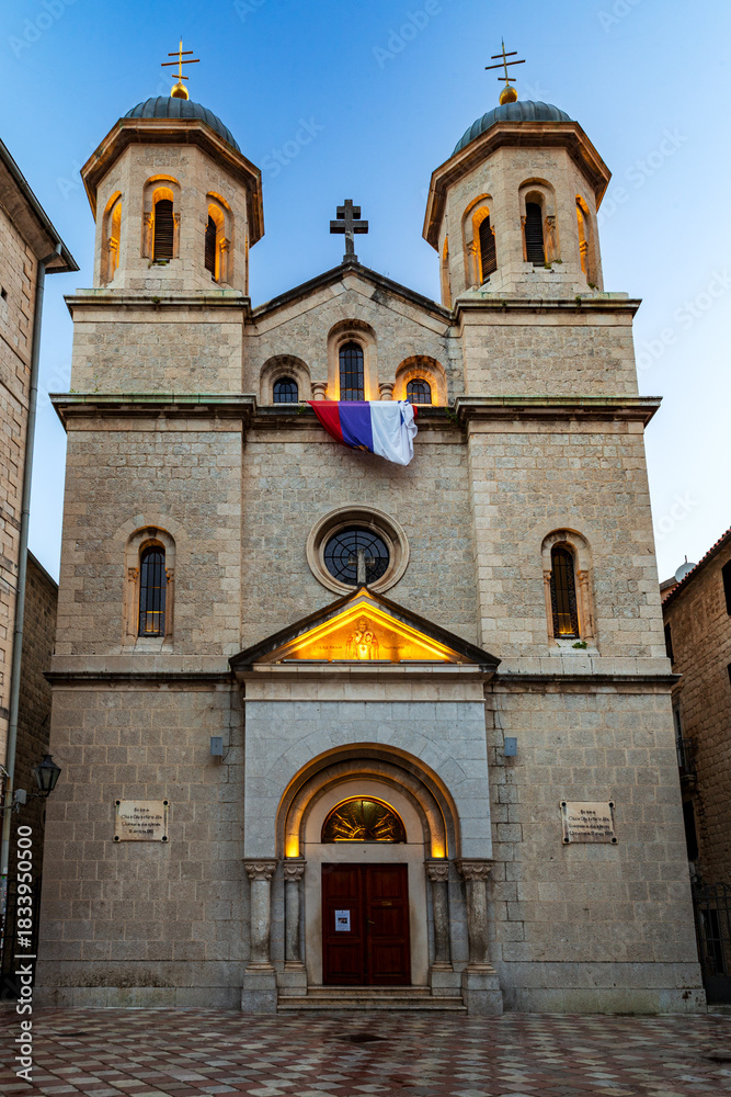 Fototapeta premium The Church of St. Nicholas a Serbian Orthodox church in the city ok Kotor at dusk. Montenegro. Vertical view.