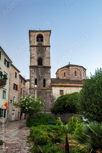 The Church of St. Mary Collegiate or the church of St. Osanna with it’s bell tower (campanile) in the city of Kotor at dawn. Montenegro. Vertical view.