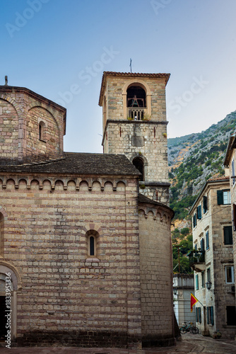 The bell tower or campanile of the Church of St. Mary Collegiate or the church of St. Osanna in the city of Kotor at dawn. Montenegro. Vertical view.