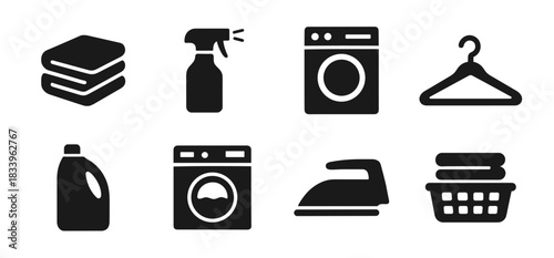 Laundry icon collection in black. Set includes folded towels, spray bottle, washing machine, clothes hanger, detergent bottle, front-load washer, iron, and laundry basket