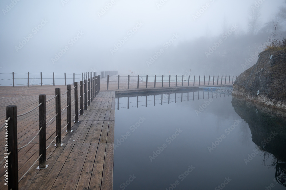 Obraz premium Foggy Lakeside Boardwalk Scene