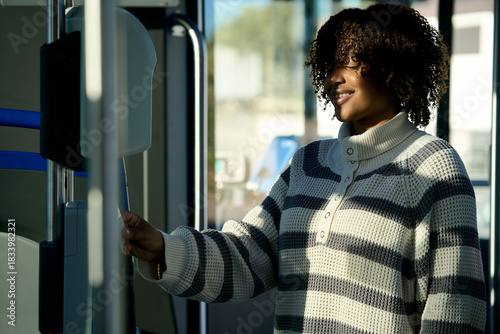 Woman paying for bus fare using transport validator