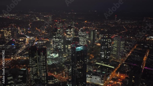 Wallpaper Mural Frankfurt skyline glowing at night with an aerial view of financial district. Modern architecture and skyscrapers like Trianon illuminate city Torontodigital.ca