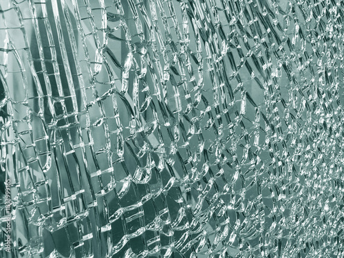 Close-up cracked pattern of tempered laminated glass panel background.