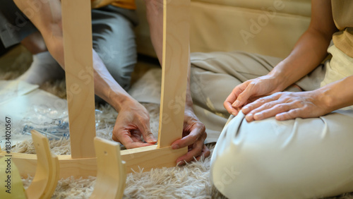 Closeup young couple assembly a new furniture at home