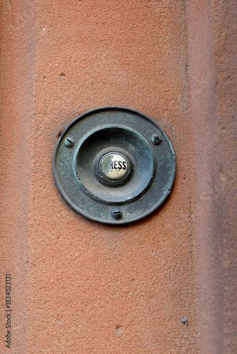Close up of Old Metal Victorian Doorbell with Ceramic Button marked 'Press'