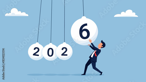 Businessman pushing a pendulum ball to start the new year 2026, symbolizing a fresh start, future goals, and business momentum