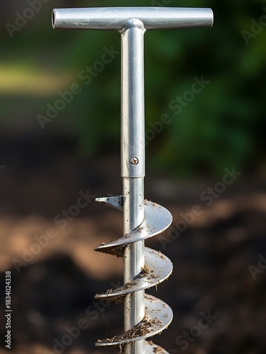 Silver metal soil auger with t-handle, earth exploration tool close-up