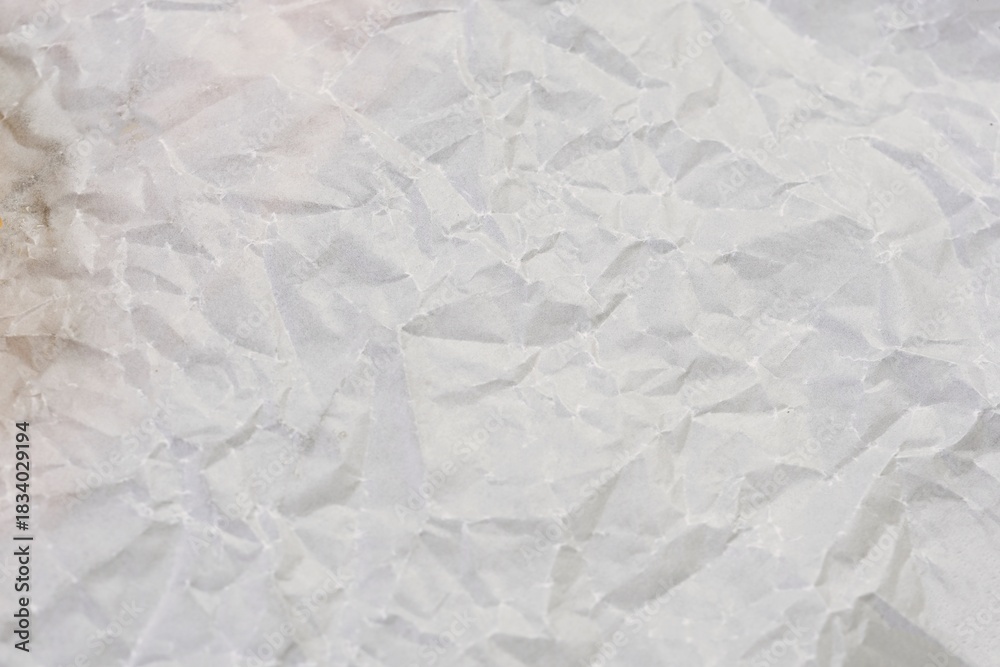 Fototapeta premium High resolution wrinkled white paper texture perfect for backgrounds, design projects, and creative layout elements.