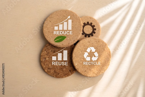 Sustainable living concept showing reduce reuse recycle on round cork coasters