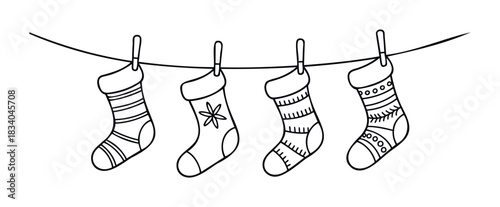 Festive Christmas stockings hanging on a line with clothespins, perfect for holiday celebration and seasonal greetings.