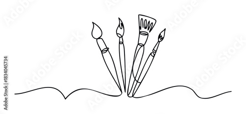 Four different types of paint brushes shown from a low angle, arranged to create a feeling of creativity and inspiration, perfect for projects related to the arts and crafts industry.