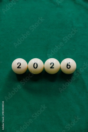 White billiard balls in a row on green cloth display number 2026. Perfect for corporate New Year campaigns, event branding, financial year planning materials, festive office decor.