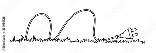 Electric plug disconnected and lying in grass symbolizing unplugged power or disconnection from the grid useful for environmental or technology themes