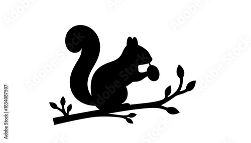 Silhouette of a squirrel sitting on a branch with leaves  