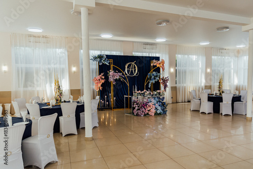 Принти на полотні Elegant wedding reception setup with floral decorations and white chairs in a sp