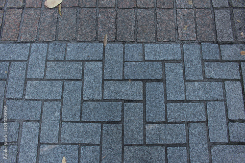 Wallpaper Mural Texture of square paving tile. Pattern of blue and brown tiles in the street. Concrete pavers with autumnal leaves close up background.	 Torontodigital.ca