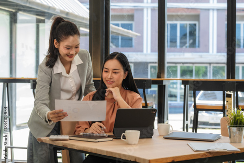 A young business team is working on a business report document on the office desk. Brainstorming Business People Design Planning, Brainstorming Planning Partnership.