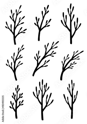 Simple black brushstroke collection of nine different stylized bare tree branches and woody winter twigs isolated on a clean white background
