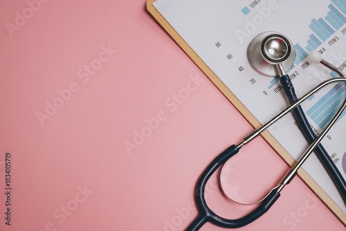 Stethoscope and medical chart with data graph on clipboard placed on pink background, symbolizing healthcare analysis and medical examination tools