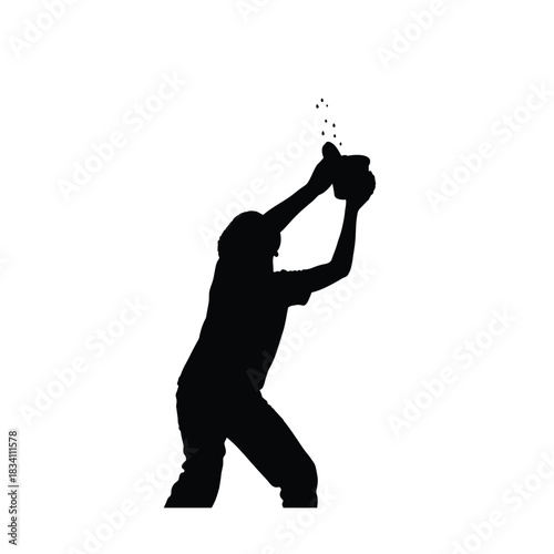 Silhouette of a person catching a ball in mid air
