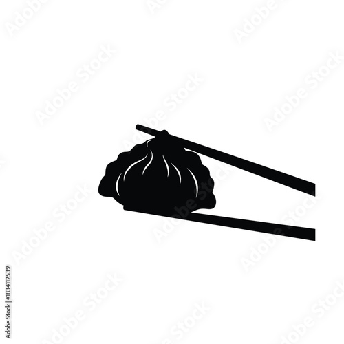 Steaming soup dumpling held by chopsticks silhouette