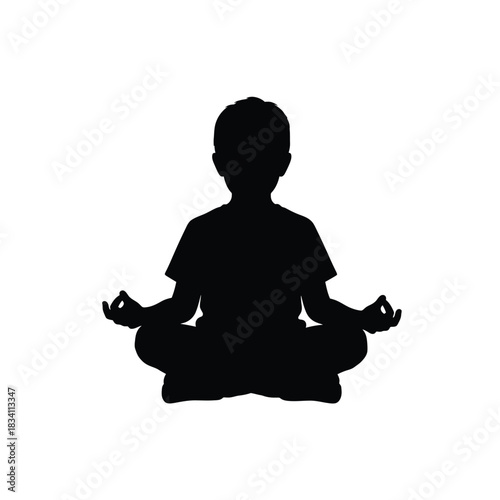 Young boy in meditation pose silhouette